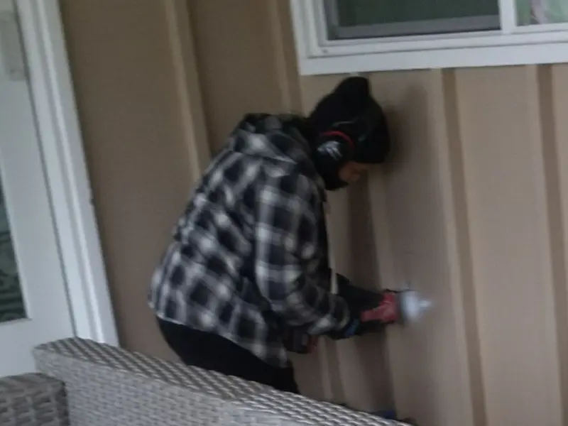 Professional electrician installing an exterior outlet in O'Fallon