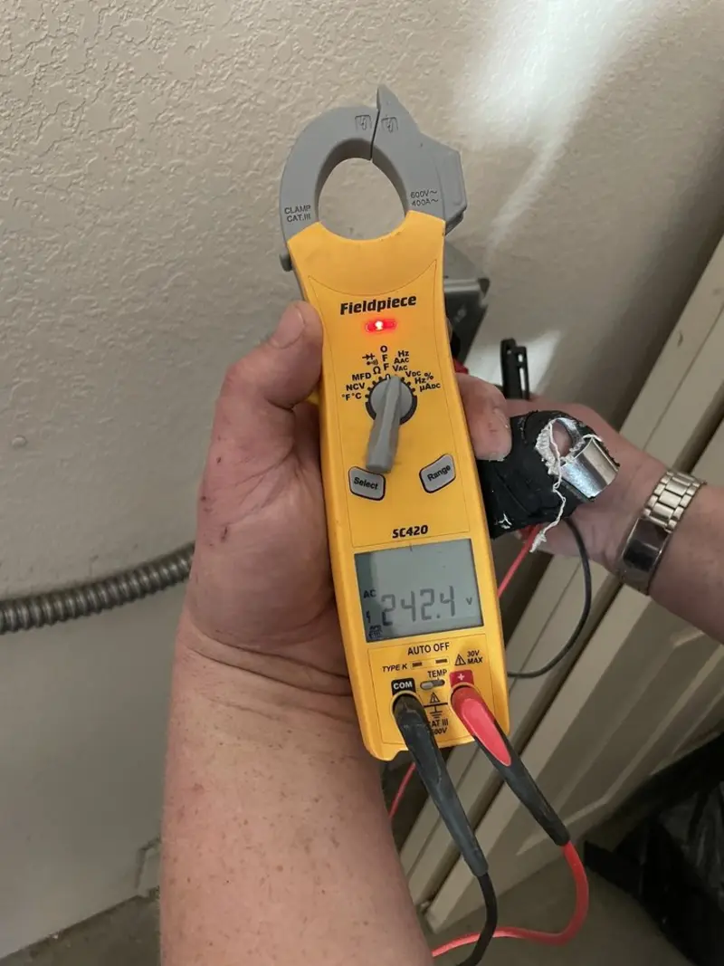 Voltage testing with clamp meter during Recessed Lighting Installation in O'Fallon